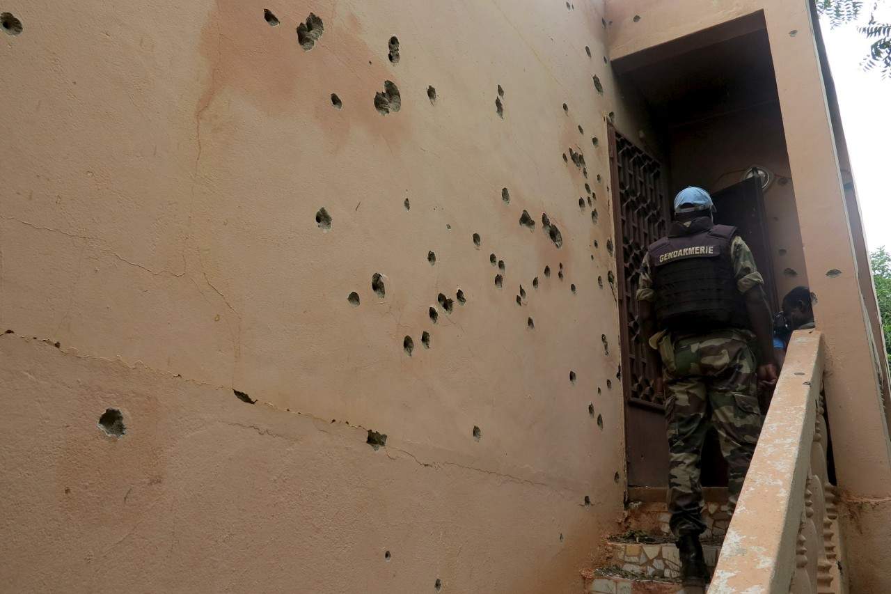 A Malian gendarme climbs stairs at the Byblos hotel, site of a siege over the weekend in which 17 people died in Sevare, Mali, August 11, 2015. Sahara-based Islamist militant group al-Mourabitoun has claimed responsibility for the siege in central Mali, Qatari-based television network Al Jazeera reported on Monday. There was no independent confirmation from the group, which is linked to al Qaeda and has been behind several attacks against Western interests in the Sahel region. REUTERS/Adama Diarra      TPX IMAGES OF THE DAY      - RTX1NXVK
